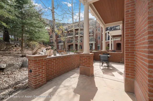 a view of outdoor sitting area with brick walls