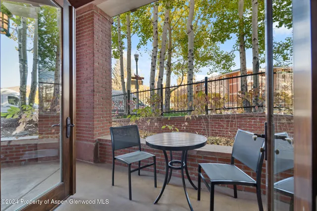 a view of a patio with a dining table and chairs