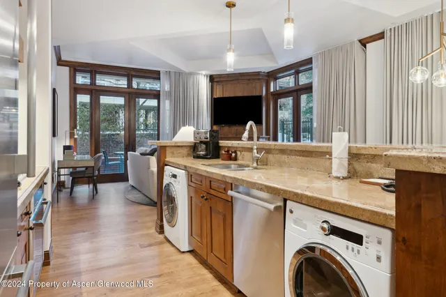 a view of living room with furniture and large windows