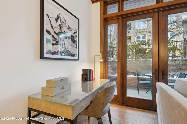 a dining room with furniture and wooden floor