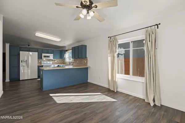 a view of kitchen with granite countertop cabinets and wooden floor