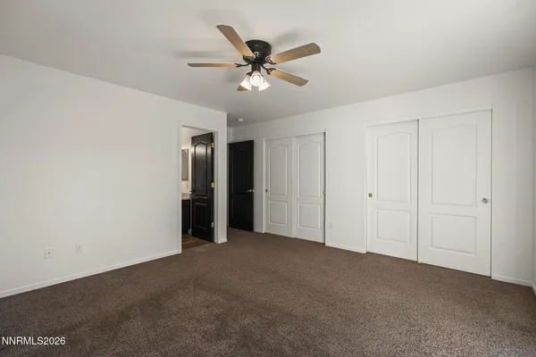 a view of an empty room with a ceiling fan