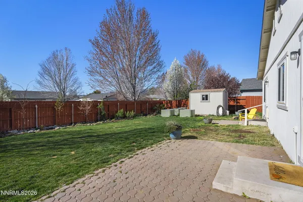 a backyard of a house with plants and trees