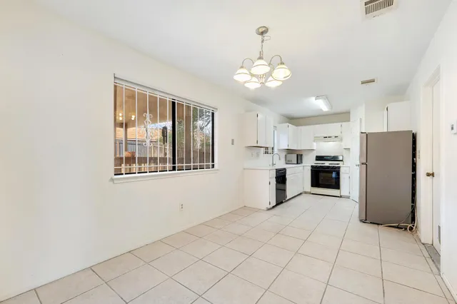 a view of kitchen with windows and refrigerator