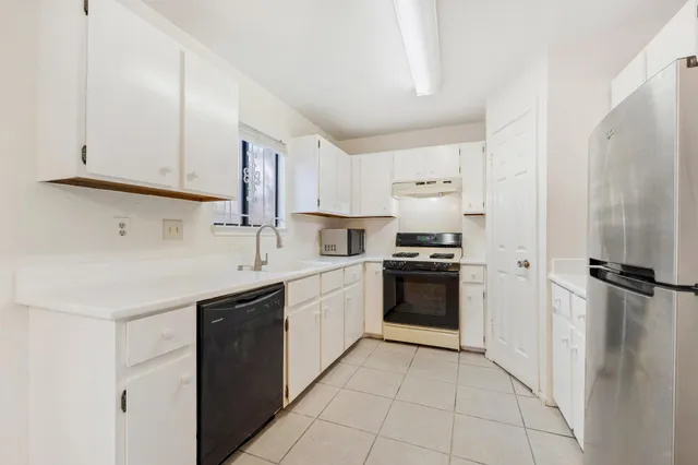 a kitchen with a sink stove and refrigerator