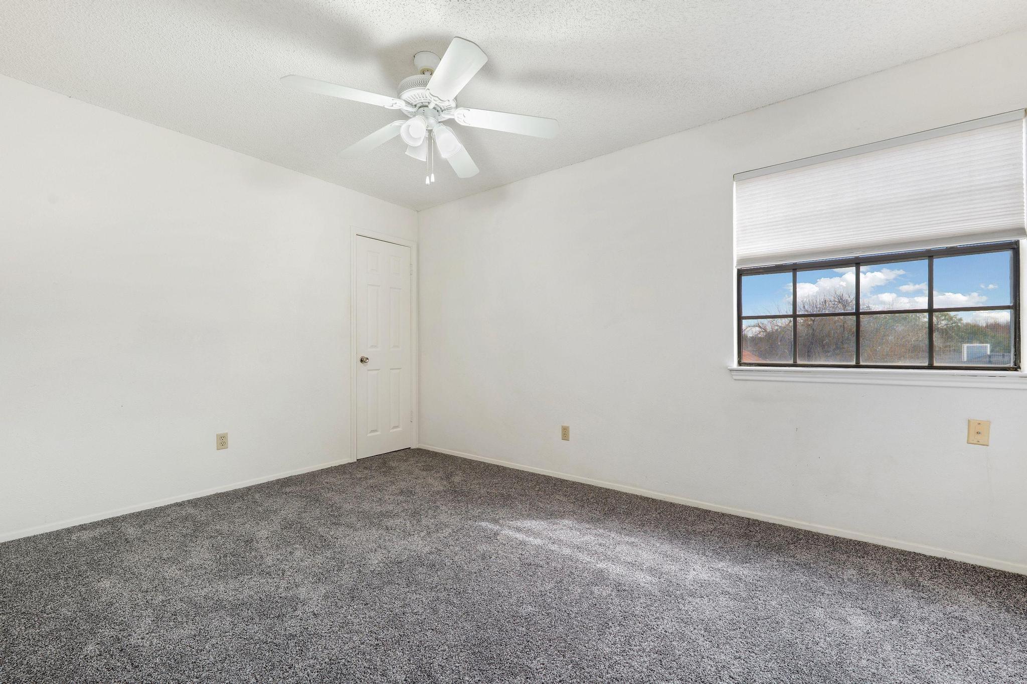 11918 Snow Finch Road Austin, TX 78758 - Photo 19 of 33 Spare room with carpet floors, a textured ceiling, and ceiling fan
