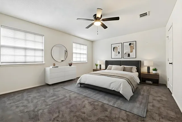 a spacious bedroom with a bed a window and closet