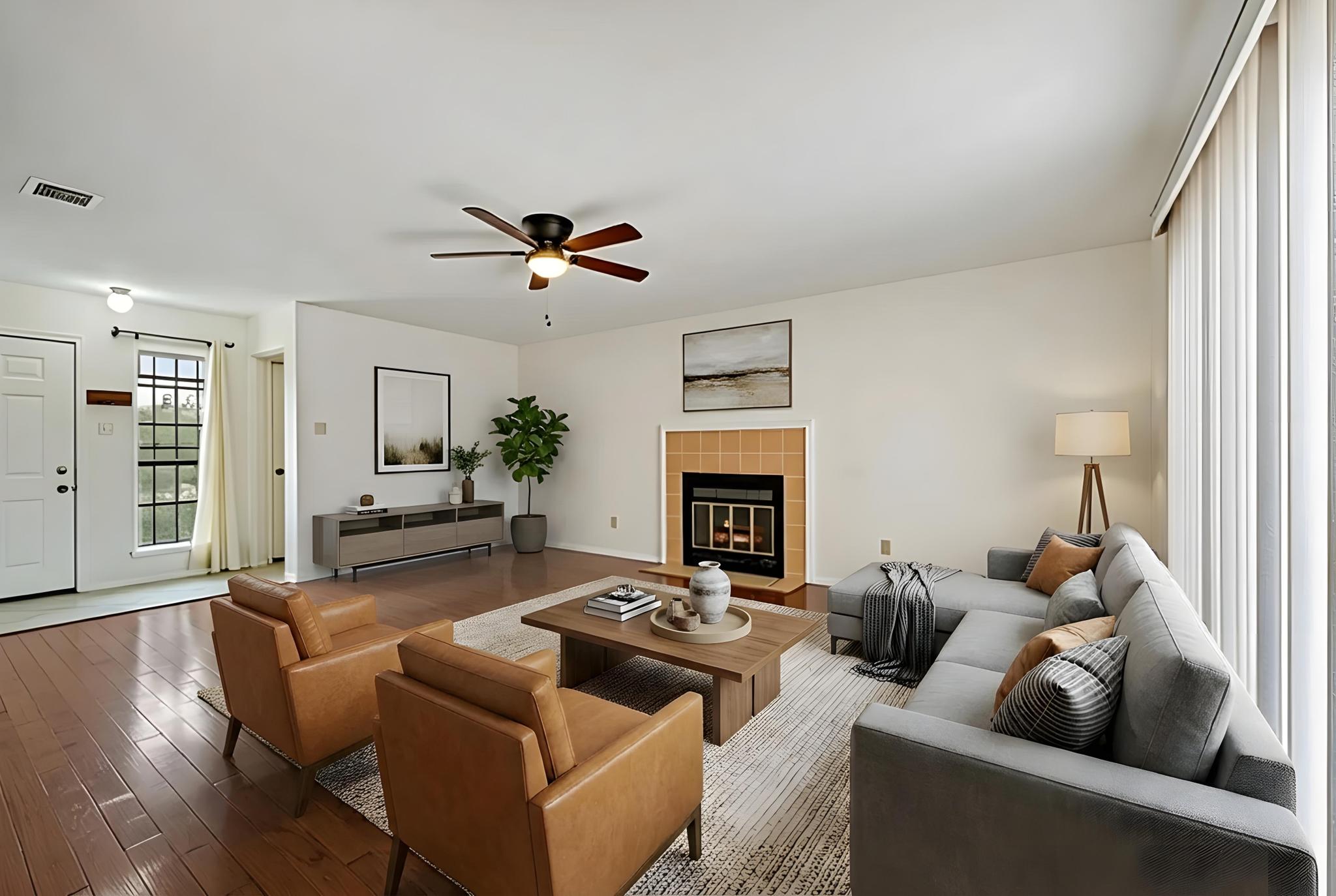 11918 Snow Finch Road Austin, TX 78758 - Photo 6 of 33 Living area featuring a tiled fireplace, wood-type flooring, and a ceiling fan