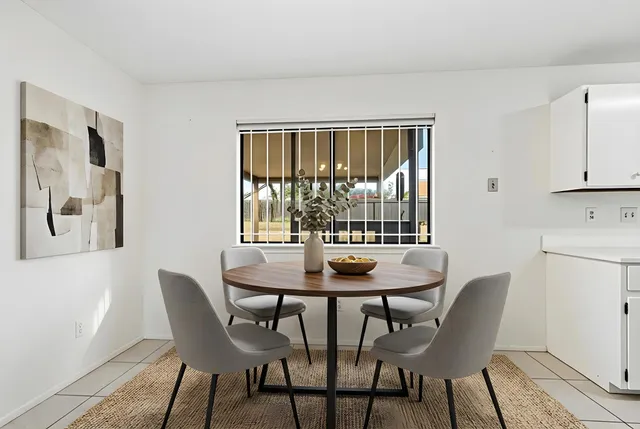 a dining room with furniture and window