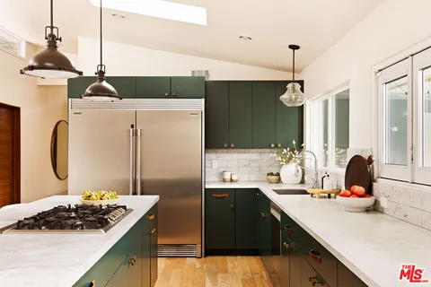 a kitchen with a sink stove and refrigerator