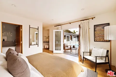 a spacious bedroom with a large bed and a couch