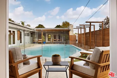 a view of a house with backyard porch and sitting area