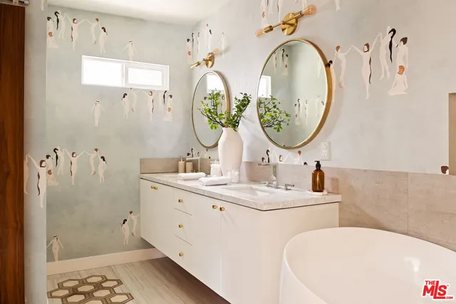 a bathroom with a tub sink and mirror