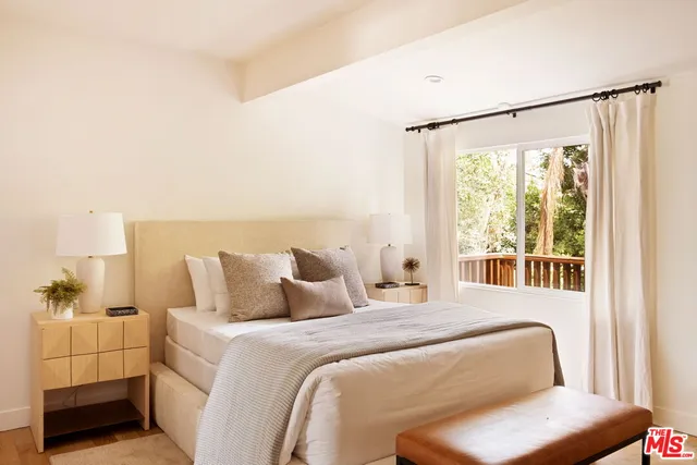 a bedroom with a bed and a window