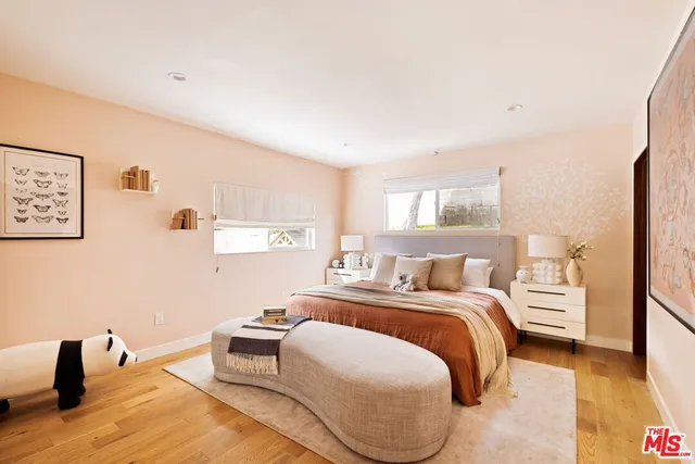 a bedroom with a bed and a large mirror