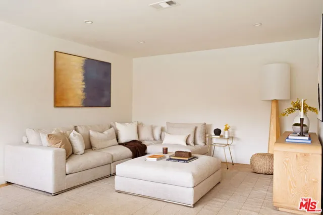 a bedroom with furniture and a lamp