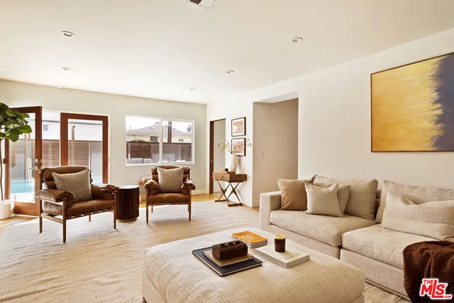 a living room with furniture and large windows