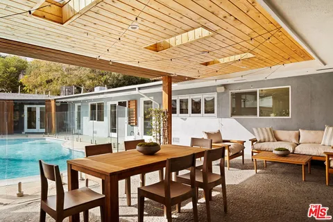 a backyard of a house with table and chairs