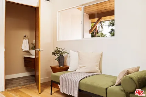 a bedroom with a bed and a painting on the wall