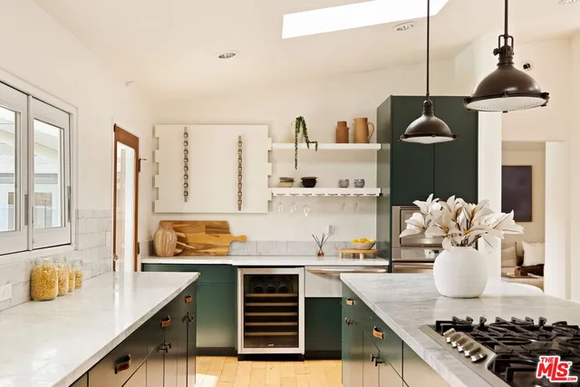 a kitchen with a sink a stove and chairs