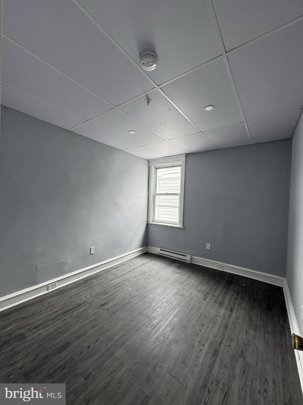 15 Church Lane, Unit 2B Lansdowne, PA 19050 - Photo 1 of 7 a view of an empty room with wooden floor and a window