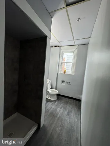 a bathroom with a toilet and a shower