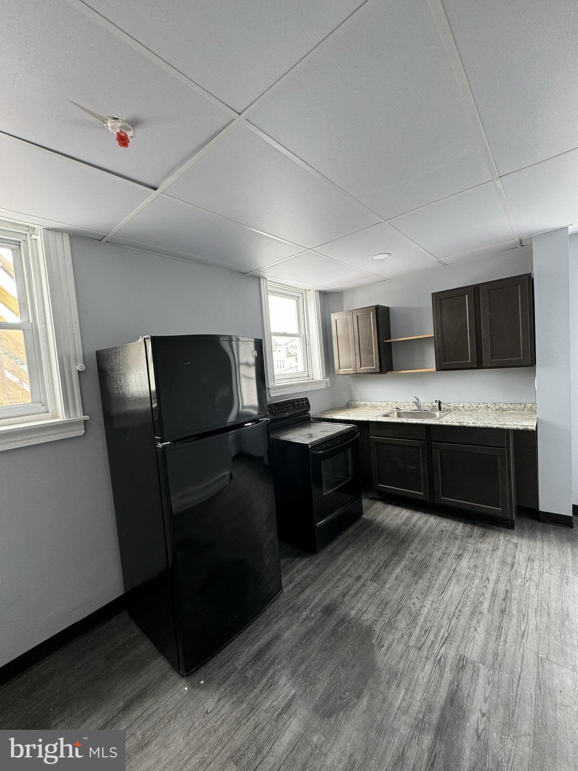 15 Church Lane, Unit 2B Lansdowne, PA 19050 - Photo 6 of 7 a kitchen with a refrigerator sink and wooden floor