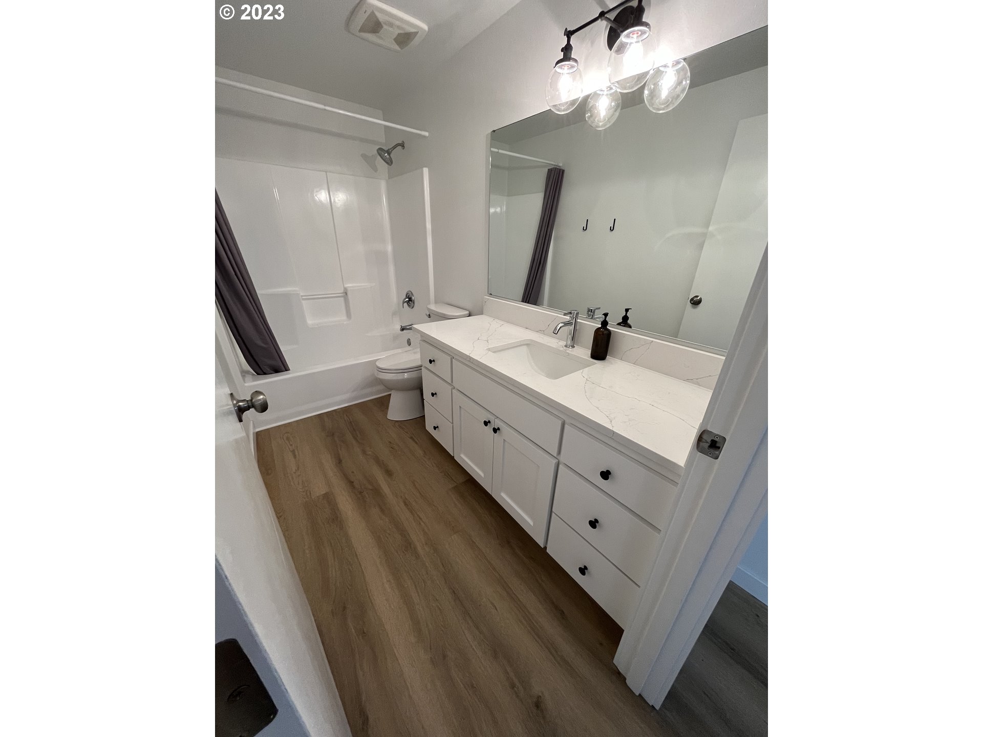 4961 Forsythia Street Springfield, OR 97478 - Photo 11 of 14 a spacious bathroom with a double vanity sink and mirror