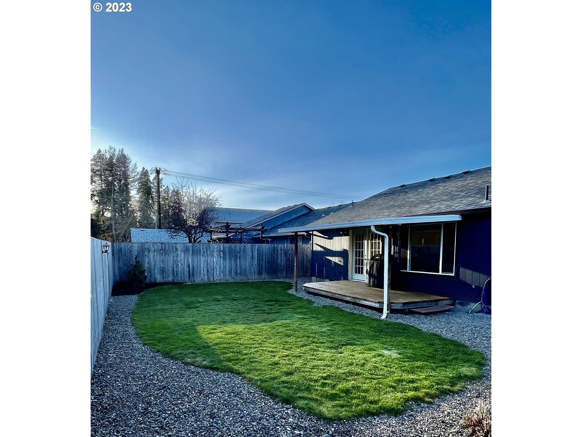 4961 Forsythia Street Springfield, OR 97478 - Photo 14 of 14 a view of a backyard with potted plants and wooden fence