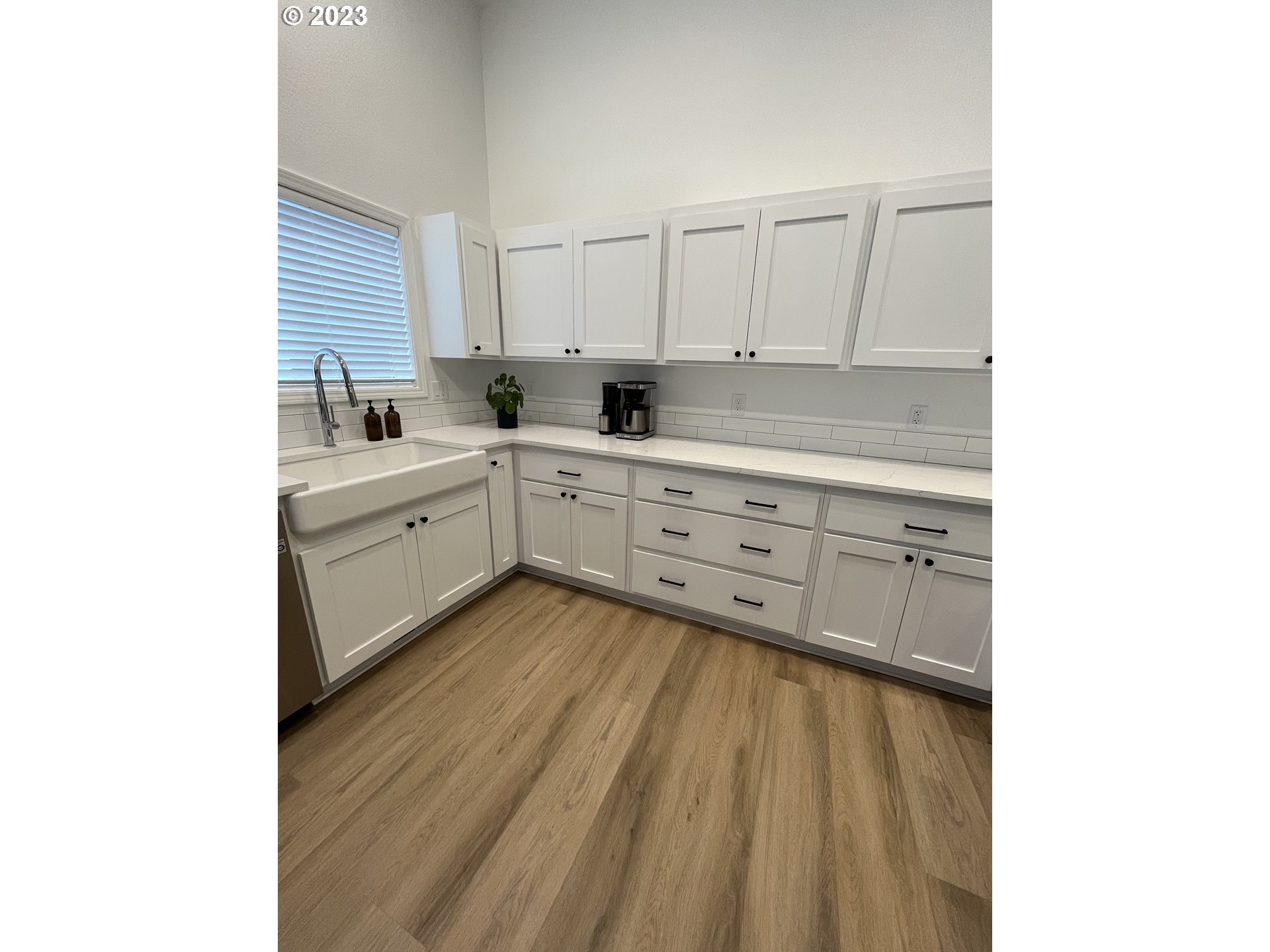 4961 Forsythia Street Springfield, OR 97478 - Photo 6 of 14 a large white kitchen with sink and cabinets