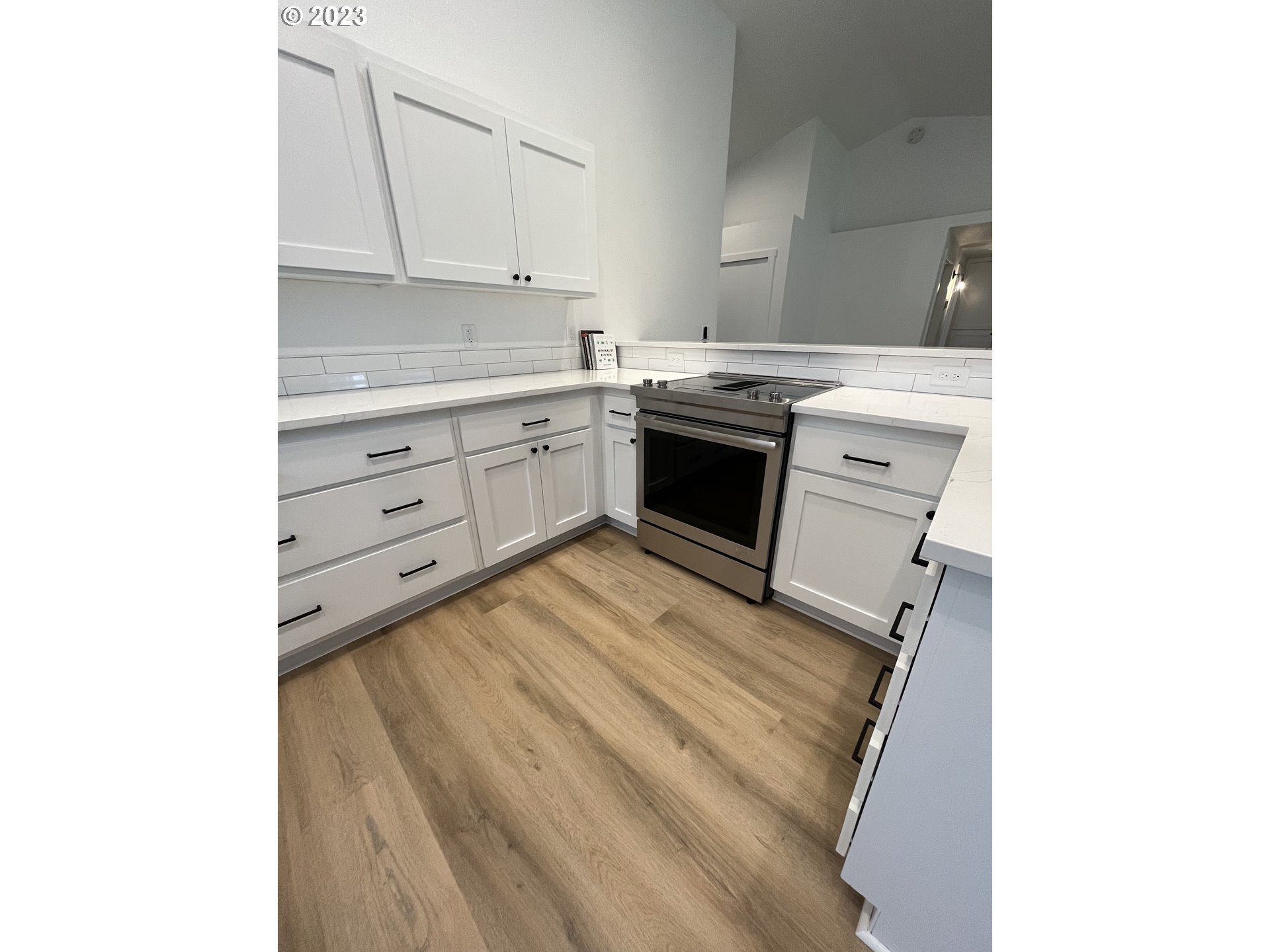 4961 Forsythia Street Springfield, OR 97478 - Photo 8 of 14 a kitchen with a stove cabinets and a sink