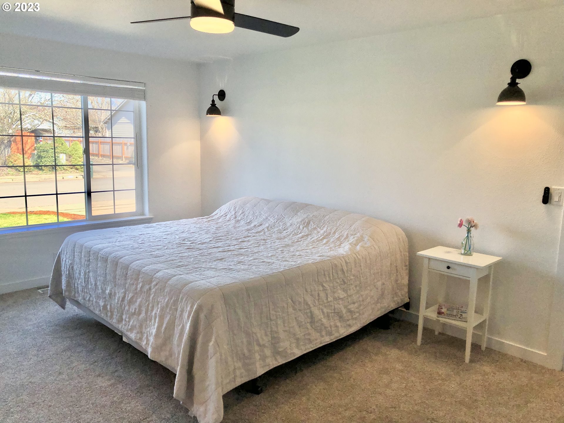 4961 Forsythia Street Springfield, OR 97478 - Photo 9 of 14 a bedroom with a bed and a chandelier
