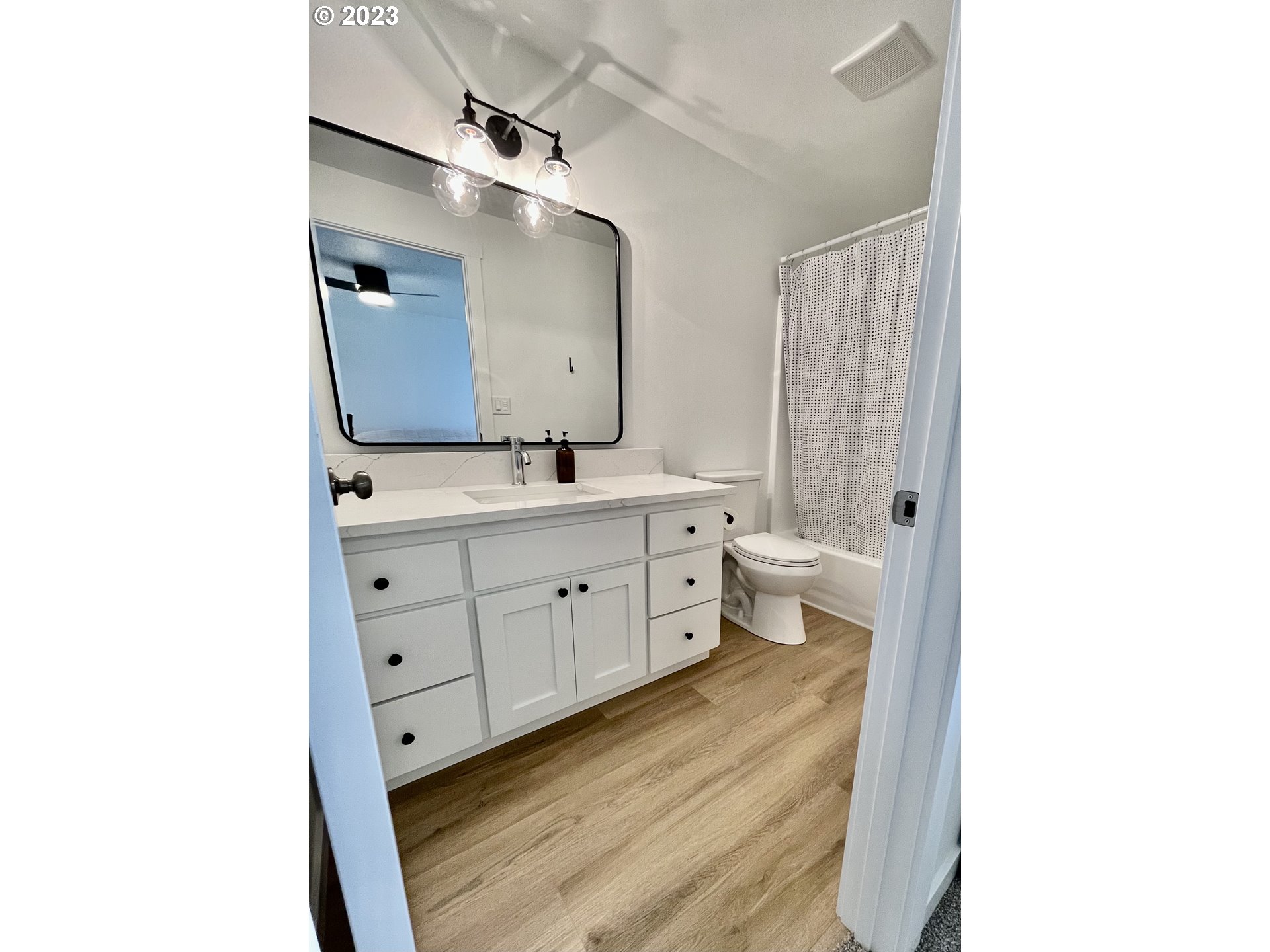 4961 Forsythia Street Springfield, OR 97478 - Photo 10 of 14 a spacious bathroom with a double vanity sink a toilet and a mirror