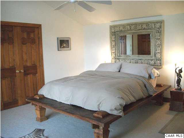 5462 Laurel Ridge Road Charlottesville, VA 22911 - Photo 31 of 50 a bedroom with a bed and a mirror