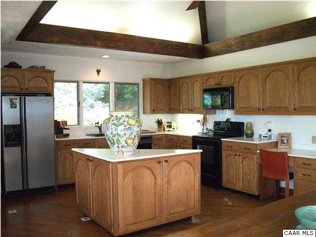 5462 Laurel Ridge Road Charlottesville, VA 22911 - Photo 39 of 50 a kitchen with stainless steel appliances granite countertop a refrigerator a sink dishwasher a stove with wooden cabinets and floor
