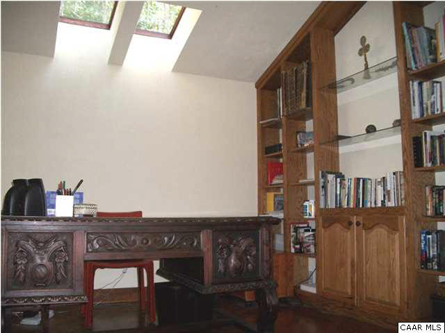 5462 Laurel Ridge Road Charlottesville, VA 22911 - Photo 48 of 50 a view of a workspace with furniture and a book shelf