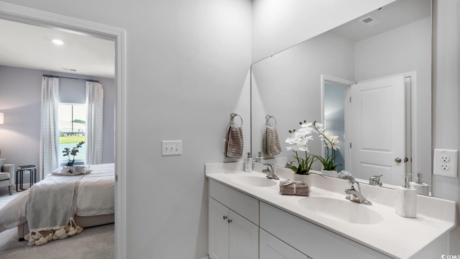 1170 Silver Perch Place Sunset Beach, NC 28468 - Photo 10 of 13 Ensuite bathroom with double vanity and baseboards