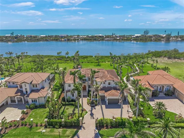 an aerial view of house with yard and lake view