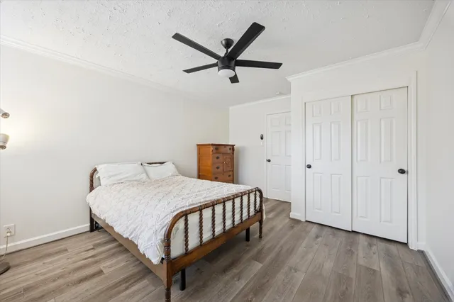 a bedroom with a bed and wooden floor