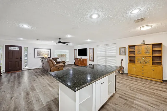 a large kitchen with kitchen island a sink table and chairs