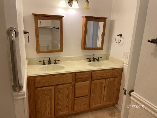 337 Peg Street Ridgecrest, CA 93555 - Photo 16 of 33 a bathroom with a double vanity sink and a mirror