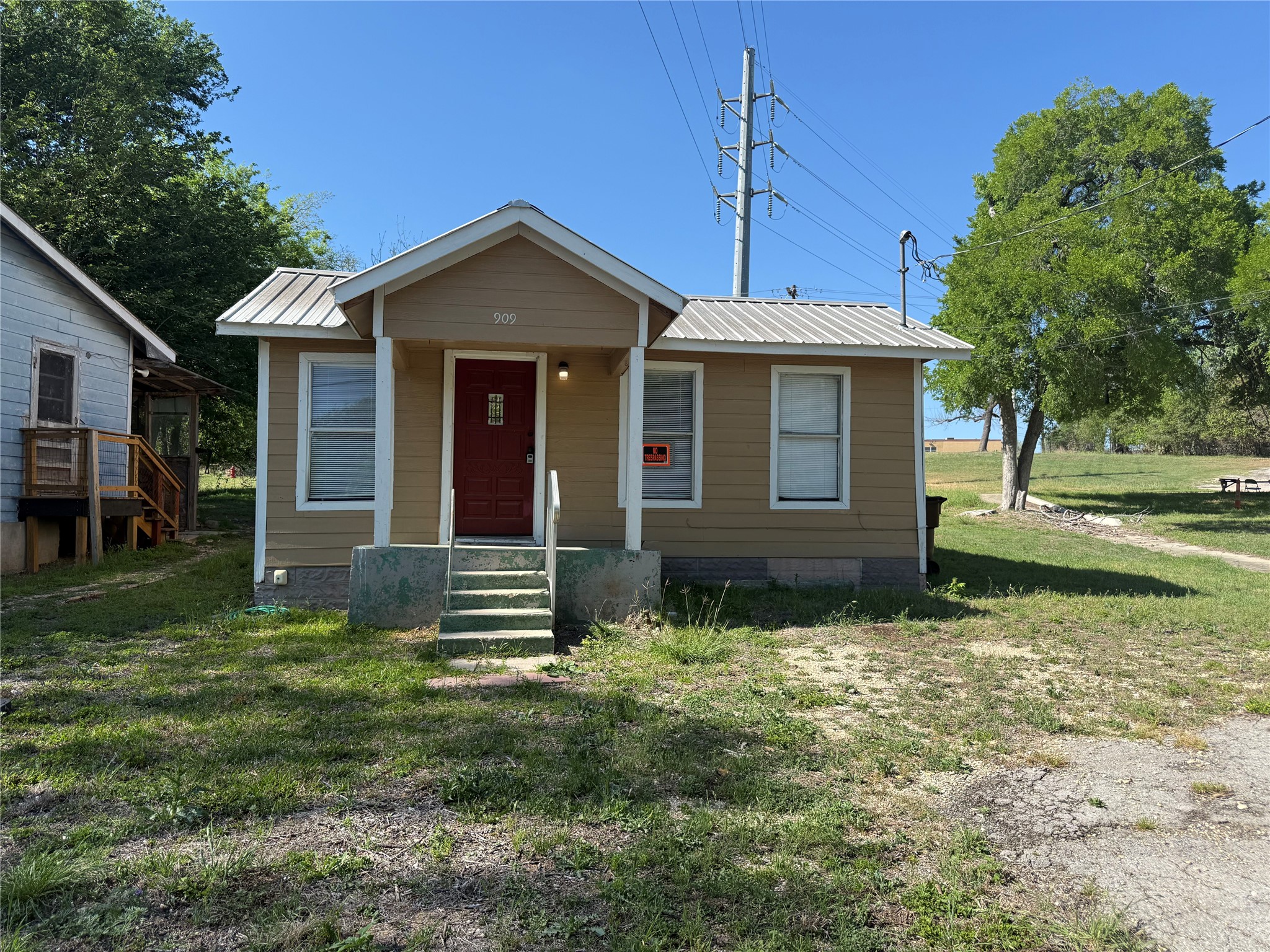 909 East Market Street Lockhart, TX 78644 - Photo 1 of 19 a front view of a house with a yard