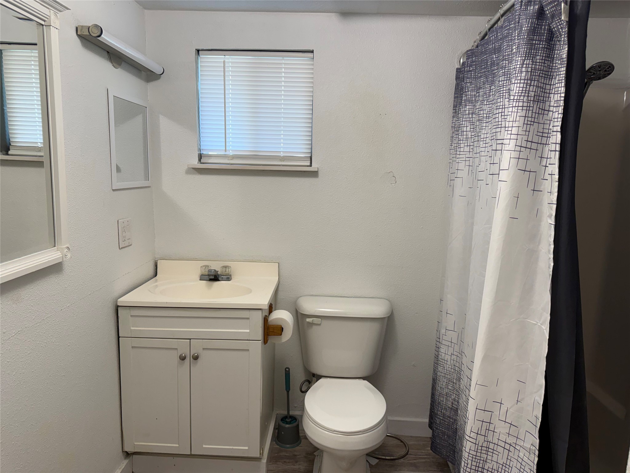 909 East Market Street Lockhart, TX 78644 - Photo 11 of 19 a white toilet sitting next to a bathroom sink