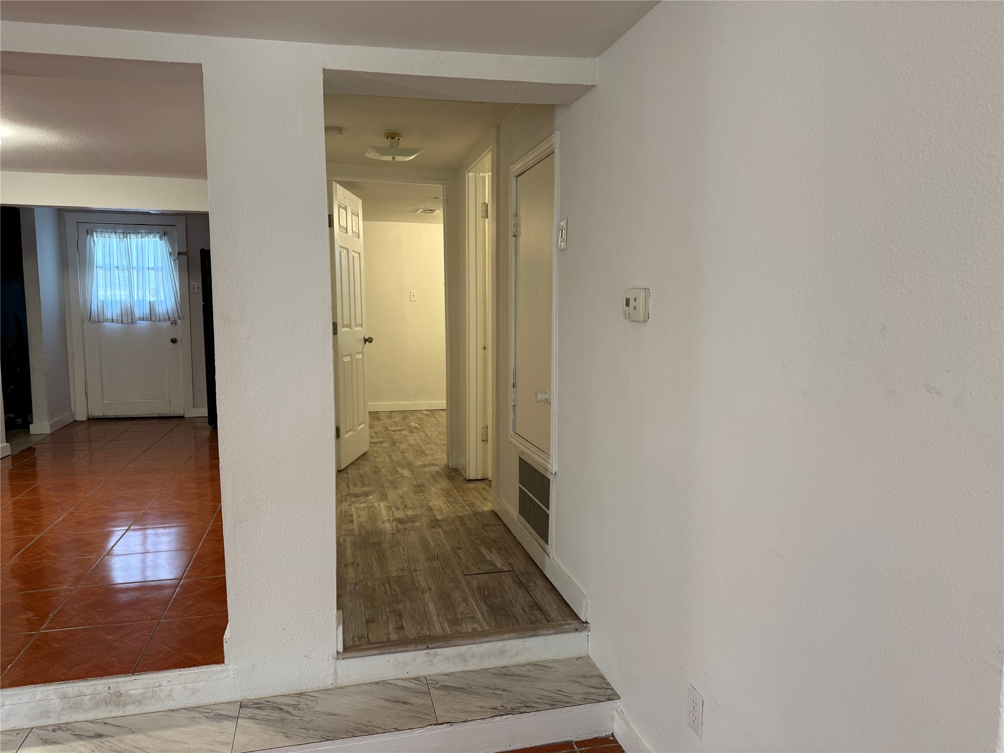 909 East Market Street Lockhart, TX 78644 - Photo 10 of 19 a view of a hallway with wooden floor and stairs