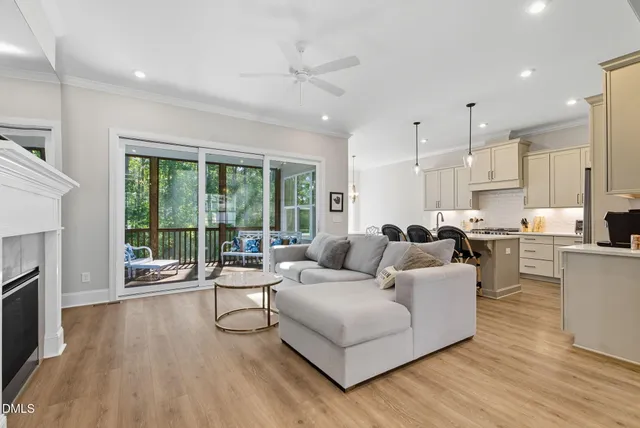 a kitchen with stainless steel appliances granite countertop a sink a stove a refrigerator and wooden floor