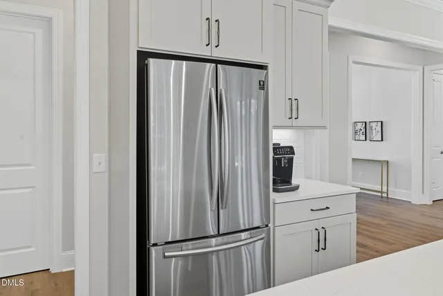 a kitchen with a refrigerator and a stove