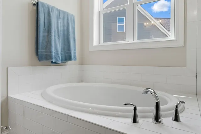 a view of walk in closet with clothes