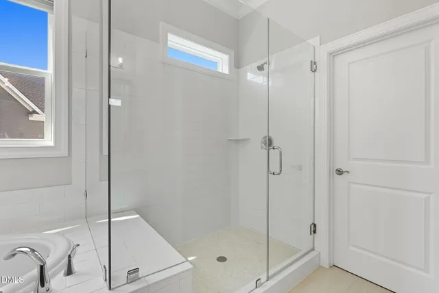 a view of walk in closet with clothes