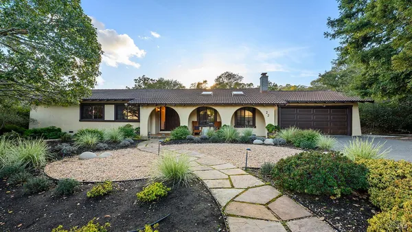 a front view of a house with garden
