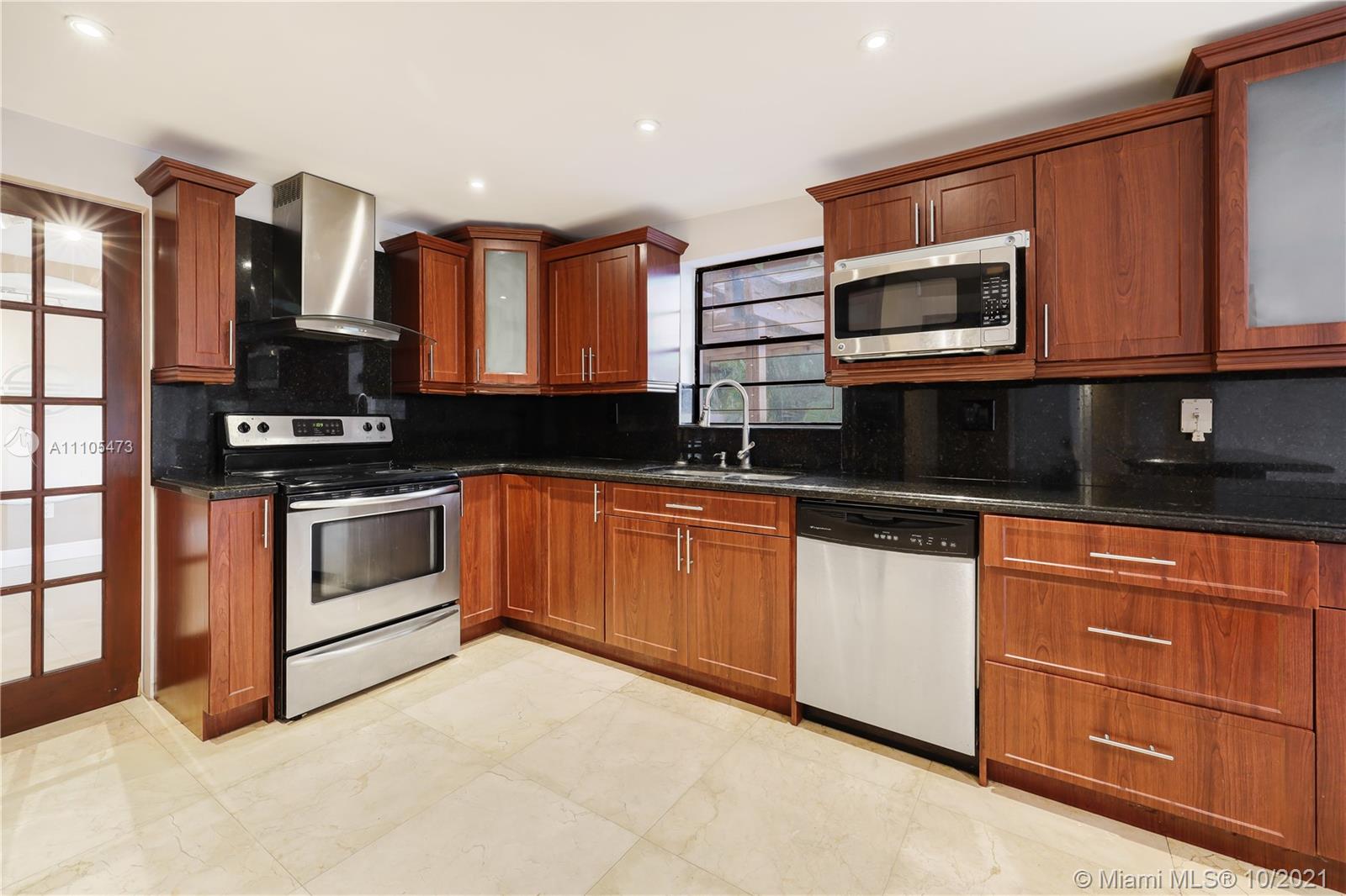 330 Southwest 133rd Place Miami, FL 33184 - Photo 13 of 51 a kitchen with stainless steel appliances granite countertop a stove a sink and a microwave